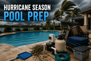 Backyard swimming pool under dark storm clouds with secured patio furniture and pool equipment illustrating hurricane season pool preparation in Florida.